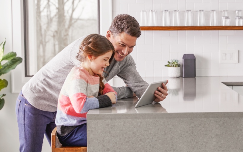 Father and daughter looking at a tablet